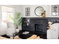 Bright living room featuring modern furnishings, decorative fireplace and plant accents at 171 S Pennsylvania St, Denver, CO 80209