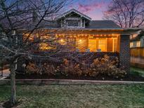 Charming brick home with a cozy front porch and beautiful landscaping, perfect for enjoying evenings at 4135 Hooker St, Denver, CO 80211