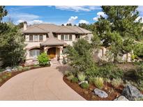 Stunning two-story home featuring a tile roof, beautiful landscaping, and a private circular driveway at 145 Capulin Pl, Castle Rock, CO 80108