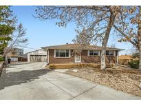 Charming brick home with a well-maintained front yard and detached garage at 5669 Johnson Ct, Arvada, CO 80002