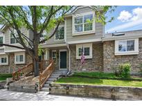 Charming townhome with stone accents, inviting curb appeal, and a well-manicured front yard at 1203 S Zeno Way # B, Aurora, CO 80017