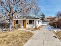 Charming home with a well-maintained front yard, a long driveway and beautiful curb appeal at 3180 S Albion St, Denver, CO 80222