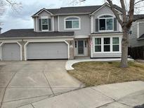 Charming two-story home with a three car garage and large driveway at 8441 Urban Ct, Arvada, CO 80005