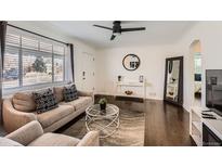 Bright living room with hardwood floors, a ceiling fan and a comfortable seating area at 5295 Perry St, Denver, CO 80212