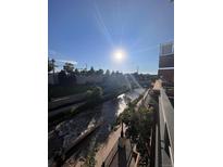 Balcony view of a rushing river on a sunny day, adding natural beauty to the property at 1438 Little Raven St # 306, Denver, CO 80202