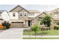 Beautiful two-story home featuring neutral siding, a covered porch, and a well-manicured lawn at 740 Meadowlark Dr, Erie, CO 80516