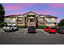 Condo exterior featuring brick accents, siding, multiple balconies, and convenient parking spaces at 875 E 78Th Ave # 9-2, Denver, CO 80229