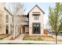 Beautiful two-story home with manicured lawn, lush landscaping, and eye-catching modern curb appeal at 1921 W 37Th Ave, Denver, CO 80211