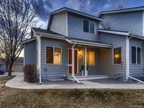 Charming two-story condo with a cozy porch, orange door, and well-maintained landscaping at 500 Lashley St # 58, Longmont, CO 80504