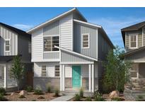 Charming two-story home featuring gray and white siding, a teal front door, and professionally landscaped front yard at 5242 Denali Blvd, Aurora, CO 80019