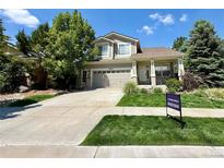 Charming two-story home with a well-manicured front yard and attached two car garage at 16063 E 106Th Ct, Commerce City, CO 80022