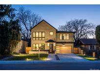 Stunning two-story home with a brick facade, large windows, and a modern garage door at 355 Forest St, Denver, CO 80220