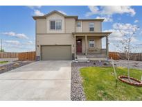 Charming two-story home featuring a covered front porch and attached two-car garage at 2201 Monte Vista St, Fort Lupton, CO 80621