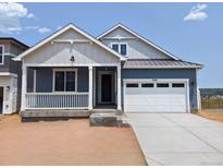 Charming single-Gathering home with a covered porch and a two-car garage, painted in pleasing neutral colors at 8326 Cokedale Cir, Littleton, CO 80125