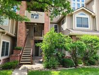 Inviting exterior of a multi-story condo building with well-maintained landscaping and a staircase leading to the entrance at 4760 S Wadsworth # 301, Littleton, CO 80123