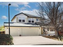 Two-story house with a three-car garage and landscaped yard at 16355 Flintlock Ct, Parker, CO 80134