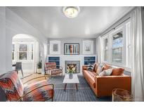 Bright living room with fireplace and comfortable seating at 2236 Jasmine St, Denver, CO 80207