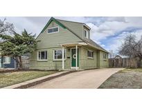 Charming two-story home featuring a well-manicured front yard and a welcoming front door with a wreath at 3640 Elm St, Denver, CO 80207