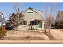 Light green two-story home with an inviting front exterior and walkway surrounded by bare trees at 3640 Elm St, Denver, CO 80207