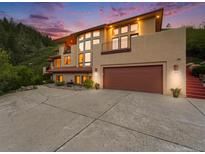 Stunning multi-level home featuring an attached garage, balcony, and picturesque mountain views at 10592 Raven Run, Littleton, CO 80125