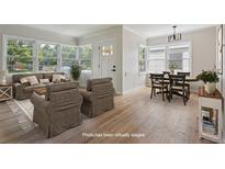 Bright living room featuring hardwood floors, a large window, and neutral decor at 2709 S Franklin St, Denver, CO 80210