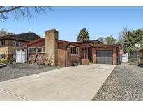 Charming brick home with a spacious driveway and attached garage at 8375 W 17Th W Ave, Lakewood, CO 80214
