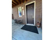 Inviting front door with stylish brick facade and cozy outdoor seating area at 2383 S Troy Ct, Aurora, CO 80014