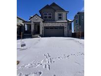 Beautiful two-story home features a stone facade and attached two car garage at 394 Grey Rock St, Brighton, CO 80601