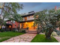 Two-story craftsman home with a welcoming front porch and landscaped lawn at 2845 N Vine St, Denver, CO 80205