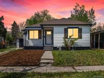 Charming home with a well-manicured lawn, fresh mulch, and sidewalk leading up to the front door at 449 King St, Denver, CO 80204