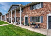 Charming brick townhome with classic architectural details and well-maintained front lawn at 14034 E Utah Cir, Aurora, CO 80012