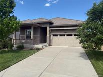 Charming ranch-style home with a well-manicured lawn and a two-car garage at 15852 Lavender Pl, Broomfield, CO 80023