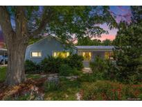 Charming single story home with mature landscaping and colorful flower beds at 2440 Saulsbury St, Lakewood, CO 80214