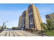 Condominium tower exterior featuring clean lines, glass windows, and well-maintained surrounding landscape at 7865 E Mississippi Ave # 1502, Denver, CO 80247