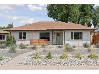 Charming single-story home boasts a well-manicured front yard with xeriscaping and lovely drought-tolerant plants at 3440 N Harrison St, Denver, CO 80205