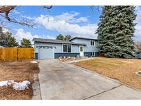 Charming two-story home with a manicured lawn and an attached one car garage at 3089 S Winston St, Aurora, CO 80013