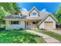 Charming home featuring dormer windows, a well-kept lawn, and an attached one-car garage at 6971 S Valentia St, Centennial, CO 80112
