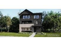 Modern two-story home featuring a stylish two-tone exterior and well-manicured lawn at 8854 Waterleaf Ln, Littleton, CO 80125