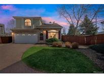 Charming two-story home with a brick driveway, well-manicured lawn, and a blend of brick and siding facade at 20000 Mitchell Pl # 9, Denver, CO 80249