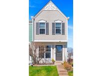 Charming two-story home featuring scalloped siding, decorative gable, and a well-manicured front lawn at 10715 Foxwood Ct, Parker, CO 80138