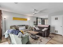 Cozy living room featuring comfortable seating, a ceiling fan, and natural light at 2487 Rainbow Dr # C51, Denver, CO 80229