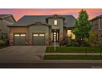 Charming home with a two-car garage, complemented by lush landscaping and a warm, inviting exterior at 2113 Fountain Cir, Erie, CO 80516