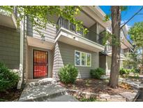 Inviting townhouse exterior with red front door, balcony, and landscaped front yard at 1635 N Franklin St, Denver, CO 80218