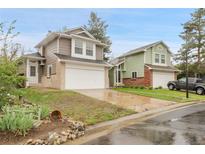 Two-story homes featuring attached garages, neat front yards, and classic brick and siding exteriors at 16928 Dandelion Way, Parker, CO 80134