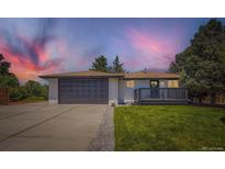 Charming single-story home features an attached garage, deck, and well-maintained front lawn at 4475 S Routt St, Littleton, CO 80127