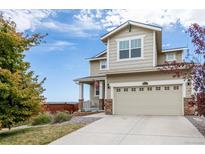 Charming two-story home features a two-car garage, inviting porch, and well-maintained landscaping at 10554 Casper Pt, Parker, CO 80134