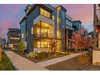 Modern townhouse with a balcony and manicured landscaping, showcasing contemporary design at 6776 Navajo Way, Denver, CO 80221