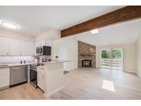 Bright, updated kitchen featuring granite countertops, stainless steel appliances, and a breakfast bar at 10251 W 44Th Ave # 3-204, Wheat Ridge, CO 80033