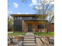 Modern home with a well-manicured lawn, natural stone accents, and a welcoming covered porch at 1100 S Elizabeth St, Denver, CO 80210