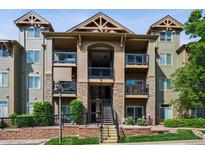Attractive multi-story condo building with stone accents, private balconies and manicured landscaping at 8778 S Kipling Way # 304, Littleton, CO 80127